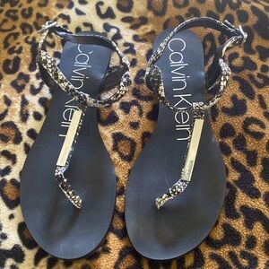Black & white snake sandals with silver metallic tags.